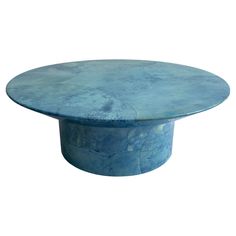 a round blue table sitting on top of a white floor