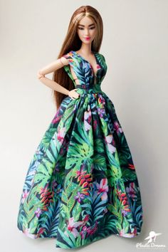 a barbie doll wearing a tropical print dress