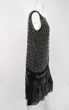 For Sale on 1stDibs - 1920s Black and White Beaded Rhinestone Silk Chiffon Dress. Drop waist silhouette with two tier skirt. White beading with additional rhinestones in circular Dress Drop Waist, Silk Chiffon Dress, Tiered Skirts, Skirt White, Tier Skirt, White Beads, Silk Chiffon, Drop Waist, Chiffon Dress