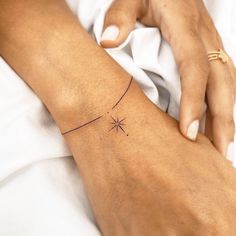 a woman's arm with a small star tattoo on the left side of her arm