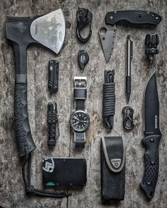 an assortment of knives and tools laid out on the ground