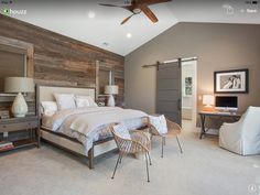 a bedroom with a bed, chair and desk in it's center area that has wood paneling on the walls