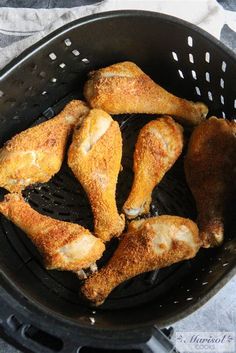 chicken wings are fried in a frying pan