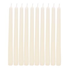 six white candles lined up in a row