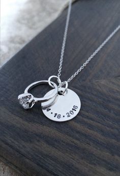 An adorable gift for her!   A 5/8 sterling silver disc is personalized with your anniversary date and hangs next to an engagement ring charm on an 18 sterling silver chain. Any important date of yours can be stamped on the necklace - wedding, engagement, first date! Please Personalized Necklaces For Anniversary, Hallmark Round Pendant Jewelry For Anniversary, Personalized Round Pendant Jewelry For Anniversary, Personalized Jewelry For Anniversary With Round Pendant, Hand Stamped White Gold Jewelry For Wedding, Hand Stamped White Gold Wedding Jewelry, White Gold Hand Stamped Jewelry For Wedding, Sterling Silver Stamped Jewelry For Anniversary, White Gold Hand Stamped Wedding Jewelry