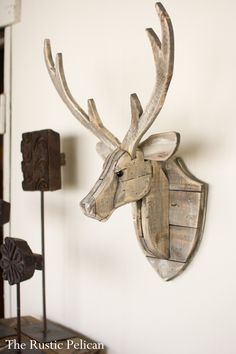 a wooden deer head mounted to the side of a wall