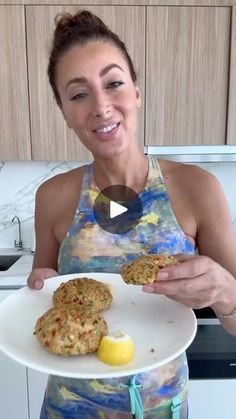 a woman holding a plate with cookies and an egg on it