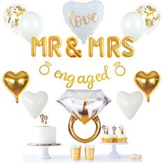 a table topped with balloons, cake and cupcakes next to a sign that says love mr & mrs engaged