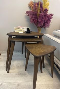 three wooden tables sitting next to each other