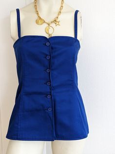 "80s Beautiful Yves Saint Laurent Rive Gauche 100% cotton top in the typical YSL blue Closes with 6 buttons on the front Unlined Made in France Size :                38FR US6 UK10 Chest :                80cm 31 1/2\" Belt :                    80cm 31 1/2\" Length :              42cm 16 1/2\" Bustier bottom  45 cm 17 3/4\" In excellent condition. Seems to have never been worn" Vintage Sleeveless Buttoned Tops, Vintage Sleeveless Tops With Button Closure, Fitted Cotton Tank Top With Buttons, Fitted Blue Tank Top With Button Closure, Vintage Blue Sleeveless Top, Blue Cotton Buttoned Tank Top, Blue Retro Tops With Buttons, Rive Gauche, Summer Blue