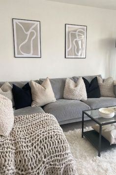 a living room filled with furniture and pillows on top of a white carpeted floor