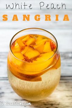 a glass filled with white peach sanggria