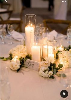 a table with candles and flowers on it