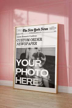 an advertisement for the new york news is displayed in front of a pink wall