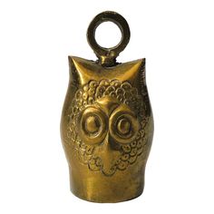 an owl shaped vase is sitting on a white surface with a ring around it's neck