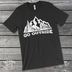 Go Outside ShirtThis Go Outside T-Shirt sends the perfect message to get outside and enjoy the finer things in life, fresh-air, sunshine.  It is even better when you can rock this shirt on a mountain hike or while camping.This t-shirt is everything you've dreamed of and more. It feels soft and lightweight, with the right amount of stretch. It's comfortable and flattering for both men and women. • 100% combed and ring-spun cotton (heather colors contain polyester)• Fabric weight: 4.2 oz (142 g/m2 Graphic Tee Shirt With Letter Print For Outdoor Activities, Outdoor Shirt With Screen Print And Relaxed Fit, Relaxed Fit Screen Print Shirt For Outdoor, Relaxed Fit Shirt With Screen Print For Outdoor, Outdoor Slogan Tops With Crew Neck, Outdoor Relaxed Fit Screen Print Shirt, Black Tops With Text Print For Outdoor, Outdoor Cotton Shirt With Letter Print, Casual Hiking Shirt With Letter Print