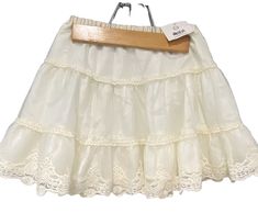 Get ready to twirl in this beautiful ivory flouncy skirt from Hanna Anderson! Made with an elastic waistband for a comfortable fit, this skirt is perfect for any party occasion. The delicate lace trim adds a touch of elegance to this Anderson piece. This skirt is brand new with tags and is a size 120/6 in US sizes. The skirt is part of the Girls' Clothing collection from Hanna Anderson. It is lined and comfortable. Don't miss out on adding this stunning piece to your little girl's wardrobe! Summer Party Cream Skirt, Party Skirt With Cream Lace Trim, Party Skirt With Cream Color And Lace Trim, Cream Party Skirt With Lace Trim, Casual Cream Party Skirt, Classy Chic Outfits, Flouncy Skirt, Hanna Anderson, Party Skirt