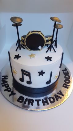 a birthday cake with musical instruments on it