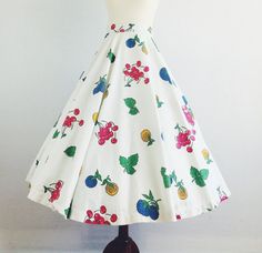 This iconic one of a kind summer 50.s skirt is a true knockout! Made of white pique fabric, it features bright bright red cherries and vibrant blue and yellow flowers along with some green leaves. The waist is fitted with a full circle skirt that hits mid calf. Metal zipper up the side for closure.So super cute!This amazing skirt is in excellent vintage condition and is approximately a modern size small. Please check measurement. Photographed with a petticoat for fullness. Petticoat not included 50s Theme Skirt, Cheap Retro Flared Skirt, Cheap Retro Full Skirt, 50s Inspired Fashion, Tea Length Tulle, Print Skirts, Floral Circle, Gold Cocktail Dress, Zebra Print Dress