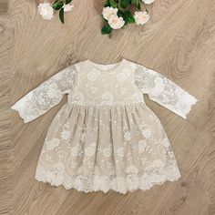 This is very pretty baby/toddler dress in beige and ivory tones. Ivory lace over beige/ecru base fabric, this stylish dress can be worn for baptism/ christening or to a wedding, or any other special occasion. The dress is made from soft pleasant fabrics, so that baby does not feel iritated.  The dress is available from baby up to size 3T White Long Sleeve Lace Dress With Scalloped Lace, Off White Scalloped Lace Dress, Elegant Long Sleeve Cream Lace Dress, White Long Sleeve Lace Dress With Lace Trim, White Lace Dress With Long Sleeves, Spring Baptism Dress With Lace Sleeves, Spring Lace Dress For First Communion, Off White Lace Dress For Baptism, Off-white Lace Dress For Baptism