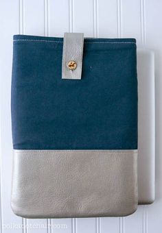 a blue and grey ipad case sitting on top of a white wall