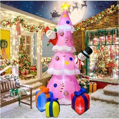 a pink christmas tree with presents around it