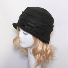 "Cloche Hat -Black Wool Felt- with raw edged bow, lined in black & white taffeta,the top is made up of 2 sections, a one piece brim and has a grosgrain ribbon band inside. One size fits all and will fit 21\" - 23\" head size. Regular Price: $65.00 SALE: $50.00 All of Bella Starr hats are made and designed from my original patterns. Caring for your hat: Dry clean only Bella Cloche can be folded for travel and all you need to do is steam or press to look good as new. Tip: If your hat is to big Fitted Brimmed Hat With Bow, Classic Brimmed Hat With Bow, Fitted Hat With Bow And Curved Brim, Fitted Wide Brim Hat With Bow, Winter Party Hats With Bow, Winter Adjustable Cloche Top Hat, Black Brimmed Hat With Bow, Classic Short Brim Hat With Bow, Black Hat With Bow And Curved Brim