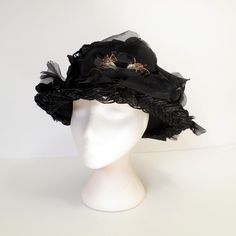 "Vintage 50's black picture hat made of braided cello straw, profusely decorated with black silk flowers and petals.  Flat-top crown and wire-edged brim.  Metal fastening comb on the inside band.  So chic and elegant.  No maker's label present.  S I Z I N G  printed sizenone fits like asmall circumference....20 1/2\" crown4\"  C O N D I T I O N  It appears there may be one flower missing at the very back.  MORE VINTAGE HATS  http://www.etsy.com/shop/JacquieVintage?section_id=6760142  BROWSE MY SHOP  http://etsy.com/shop/jacquievintage  CONNECT WITH ME  twitterjacquievintage facebookwww.facebook.com/JacquieVintage pinterestJacquie Vintage" Vintage Black Handmade Top Hat, Vintage Black Hat For Spring, Vintage Black Costume Hats For Spring, Victorian Style Adjustable Black Costume Hat, Victorian Black Top Hat With Short Brim, Black Victorian Hat For Evening, Black Victorian Hat For Wedding, Victorian Black Hat For Weddings, Black Victorian Evening Hat