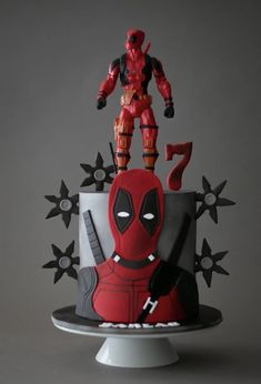 a cake with a deadpool figure on top