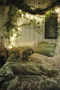 an unmade bed with green pillows and blankets on it, surrounded by greenery