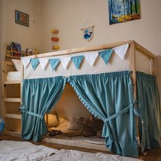 there is a bunk bed with curtains on the top and bottom, next to a child's bed