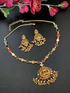 An elegant Multicolored Navaratna necklace set for your local gatherings or parties. Length of earrings : 4 cm Width : 2.5 cm Care Instruction : Avoid Heat & Chemicals Like Perfume, Deo, Alchol, Etc. | Clean With Dry Cotton Cloth | Pack In our Anti tarnish box after use. Multicolor Peacock Design Temple Jewelry Sets, Multicolor Peacock Design Temple Necklace, Multicolor Peacock Design Jewelry Sets For Diwali, Multicolor Temple Necklace With Peacock Design For Celebration, Multicolor Kundan Temple Necklace For Rituals, Multicolor Jewelry Sets For Puja And Festive Occasions, Multicolor Peacock Design Temple Necklace For Celebration, Multicolor Temple Necklace As Gift, Multicolor Festive Jewelry Sets For Puja