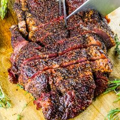 someone is cutting up some meat on a cutting board