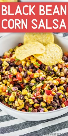 black bean corn salsa in a white bowl with tortilla chips on the side