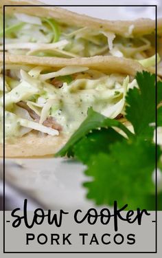 two tacos on a plate with green garnish and text slow cooker pork tacos