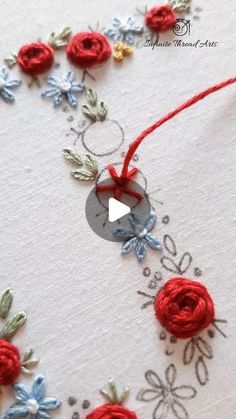 an embroidered card with red and blue flowers on the front, along with a video demonstrating how to sew