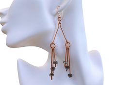 These large abstract dangle earrings made from high-quality pure copper and hematite feature hammered dangles that add incredible movement and interest. Flaunt this modern elegant look with an industrial punk feel to compliment your style and elevate any outfit. This piece is part of the Stormy collection, inspired by the moon's reflection on ocean waves. 📐 SIZING:  Total drop length is 4.5 inches. Width is 1.5 inches. ✨ MATERIALS: Every item is 100% handmade and one-of-a-kind. The wire-wrapped copper jewelry is oxidized and polished to beautifully highlight details of the wirework. Since gemstones are unique, a slight variation from the colors pictured should be expected. 🙏🏼 CARE: This piece is made from natural copper wire and will darken over time. To renew the bright shine, use a po Modern Copper Jewelry For Pierced Ears, Electroformed Rose Gold Dangle Earrings, Modern Nickel-free Copper Jewelry, Industrial Punk, Industrial Earrings, Abstract Earrings, Mixed Metal Jewelry, Chic Jewelry, Industrial Chic