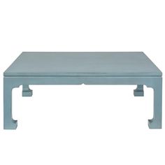 a blue coffee table sitting on top of a white floor