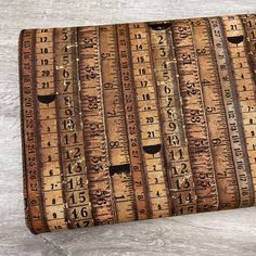 an old wooden ruler with numbers on it