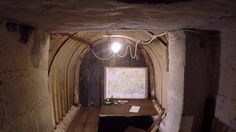 an old tunnel with a desk in it