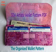 the organized wallet pattern is made with fabric and has three different pockets to hold money