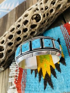 New without tags BRAND : Nizhoni Traders LLC ETHNIC & REGIONAL STYLE : Native American JEWELRY TYPE : Bracelets TYPE : Bracelet COLOR : Blue STYLE : Cuff MAIN STONE COLOR : Turquoise FEATURED REFINEMENTS : Navajo Jewelry TRIBAL AFFILIATION : Navajo SECONDARY STONE : Coral MAIN STONE : Turquoise Beautiful Navajo Kingman Turquoise, Natural Red Corali and Sterling Silver Cuff Bracelet. Absolutely amazing craftsmanship! Cuff has an inside circumference of 6 1/4 inches with a gap of 1 1/2 inches. Wid Luxury Blue Kingman Turquoise Cuff Bracelet, Luxury Traditional Turquoise Cuff Bracelet, Unique Turquoise Nickel-free Cuff Bracelet, Southwestern Style Blue Nickel-free Cuff Bracelet, Southwestern Nickel-free Turquoise Jewelry, Navajo Jewelry, Color Turquoise, Sterling Silver Cuff Bracelet, Blue Style