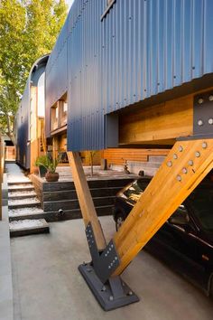 a car parked in front of a building with stairs leading up to the top floor