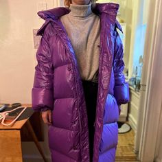 Long, Glossy Down-Insulated Paneled Puffer Coat With A High Neck And Detachable Hood. Features Internal Ribbon Straps So You Can Slip Out Of The Arms And Carry The Coat When Inside. Responsible Down Certified. Never Worn. This Gorgeous Coat Was Sadly Too Big For Me. 100% Nylon Outer, 100% Down Fill Zipper And Button Closure Detachable Hood Elasticized Cuffs Side Welt Pockets Internal Zipper Pocket Fabric: Nylon Down Color: Purple Long Puffer Coat, Long Puffer, Rachel Comey, Detachable Hood, Puffer Coat, Welt Pockets, Welt Pocket, Purple Color, Color Purple