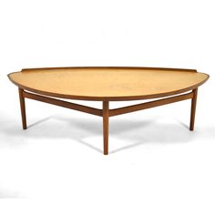 an oval wooden table with two legs and a tray on the top, against a white background