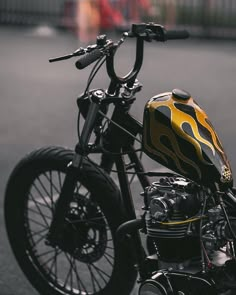 a black and yellow motorcycle parked on the street