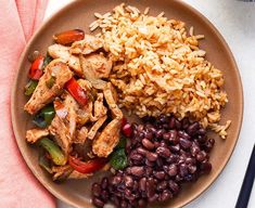 a plate with rice, beans and chicken on it