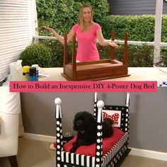 a woman standing next to a black dog in a bed made out of cardboard boxes