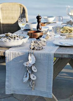 the table is set with oysters and wine glasses