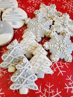 several decorated cookies on a red and white tablecloth